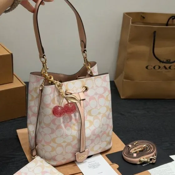 Coach Rowan Bucket Bag In Signature Canvas Pink White Signature Print Crossbody