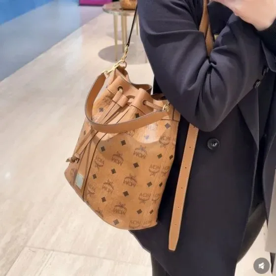 MCM Aren Visetos Drawstring Bucket Bag Cognac Crossbody
