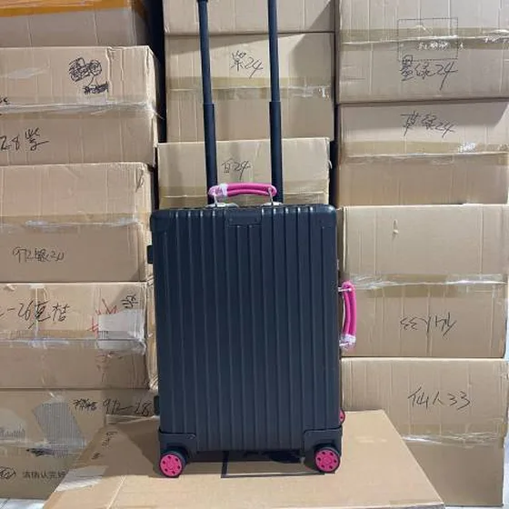 Rimowa suitcase Black with pink handles travel